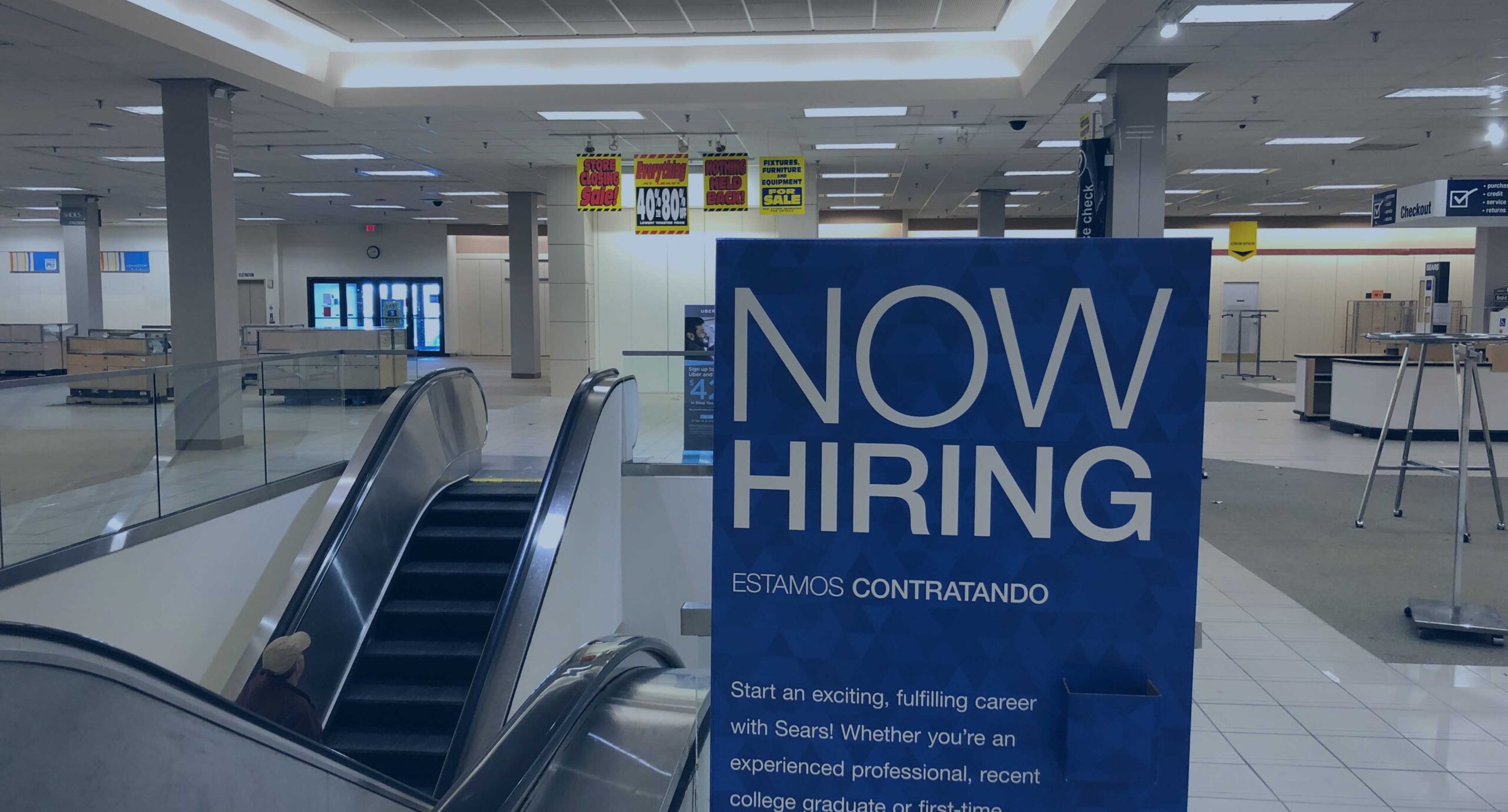 Photo of a now hiring sign in a shopping mall